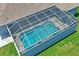 Aerial view of the home's screened-in pool with lush, green lawn at 10250 Locker Dr, Spring Hill, FL 34608