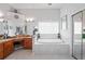 Bathroom featuring a soaking tub, dual vanities, and tiled floor at 10250 Locker Dr, Spring Hill, FL 34608