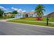 Charming home featuring a two-car garage, well-manicured lawn, and vibrant landscaping at 10250 Locker Dr, Spring Hill, FL 34608