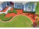 Beautifully landscaped front yard with vibrant green grass, red mulch, and a well-maintained lawn at 10250 Locker Dr, Spring Hill, FL 34608
