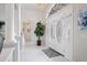 Elegant foyer featuring a chandelier, tiled floor, and an arched entryway leading to the living area at 10250 Locker Dr, Spring Hill, FL 34608