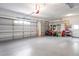 Large three-car garage with painted floor, providing plenty of room for vehicles and equipment at 10250 Locker Dr, Spring Hill, FL 34608