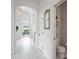 Hallway with high ceilings and tile floors leading to dining area and bathroom at 10250 Locker Dr, Spring Hill, FL 34608