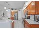 Spacious kitchen with wood cabinets, stainless steel appliances, and white countertops at 10250 Locker Dr, Spring Hill, FL 34608