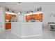 Bright kitchen featuring wood cabinets, white countertops, pendant lighting, and white tile floors at 10250 Locker Dr, Spring Hill, FL 34608