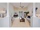 Spacious living room with high ceilings, decorative columns, neutral tones, and a view of the backyard at 10250 Locker Dr, Spring Hill, FL 34608