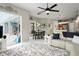 Open concept living room with a modern rug, view of outdoor dining, and a partial view of the kitchen at 10250 Locker Dr, Spring Hill, FL 34608