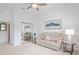 Cozy living room with a recliner sofa, elegant decor, and plenty of natural light at 10250 Locker Dr, Spring Hill, FL 34608