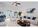 Bright living room with sliding glass doors to pool, neutral decor, and comfortable seating arrangement at 10250 Locker Dr, Spring Hill, FL 34608
