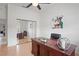 Bright home office with wood floors, ceiling fan, and mirrored closet doors at 10250 Locker Dr, Spring Hill, FL 34608