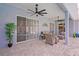 Inviting covered patio with ceiling fans, wicker furniture, and sliding glass doors to the interior at 10250 Locker Dr, Spring Hill, FL 34608