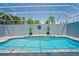 Screened in pool with clear blue water and pavers at 10250 Locker Dr, Spring Hill, FL 34608
