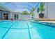 This pool has a screened enclosure with patio and clear blue water at 10250 Locker Dr, Spring Hill, FL 34608
