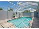 The pool has a screened enclosure with an in-ground pool and plants at 10250 Locker Dr, Spring Hill, FL 34608