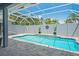 Screened in pool with pavers, plants, and blue water at 10250 Locker Dr, Spring Hill, FL 34608