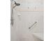 Modern shower with tiled walls, shower head, and a convenient grab bar for safety at 10250 Locker Dr, Spring Hill, FL 34608