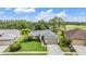 Stunning aerial view of a single-story home with lush landscaping and a golf course nearby at 1033 Ashbourne Cir, Trinity, FL 34655