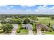 Scenic aerial shot of homes and mature trees surrounding the golf course, with community views at 1033 Ashbourne Cir, Trinity, FL 34655