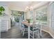 Bright dining area features a sliding glass door, backyard views and chandelier lighting at 1033 Ashbourne Cir, Trinity, FL 34655