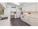 Clean kitchen with white cabinets, stainless steel appliances, and built-in desk area at 1033 Ashbourne Cir, Trinity, FL 34655