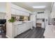 Modern kitchen with white cabinetry, laminate countertops, and stainless steel appliances at 1033 Ashbourne Cir, Trinity, FL 34655