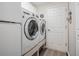 Conveniently located laundry room with modern, front-load washer and dryer on risers and storage at 1033 Ashbourne Cir, Trinity, FL 34655