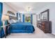 Serene main bedroom with plush carpeting, a ceiling fan, and slider doors at 1033 Ashbourne Cir, Trinity, FL 34655