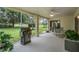 Large screened patio overlooking a well-maintained yard, and a grill at 1033 Ashbourne Cir, Trinity, FL 34655