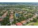 Community aerial view showing the layout of homes and community features, including ponds and greenery at 10531 Pontofino Cir, Trinity, FL 34655