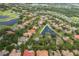 Aerial view showcases the Champions Club community, amenities, and golf course at 10531 Pontofino Cir, Trinity, FL 34655