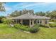Lovely backyard featuring a screened lanai, lush lawn, and mature landscaping, enhancing privacy and appeal at 10531 Pontofino Cir, Trinity, FL 34655