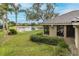 Scenic backyard view featuring a serene lake with fountain and palm trees at 10531 Pontofino Cir, Trinity, FL 34655