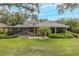 Well-manicured backyard featuring a screened pool and patio area with lush landscaping, offering a private retreat at 10531 Pontofino Cir, Trinity, FL 34655