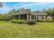 Expansive backyard features a screened lanai, lush lawn, and manicured landscaping, creating a private oasis at 10531 Pontofino Cir, Trinity, FL 34655