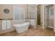 Luxurious bathroom with freestanding tub, walk-in shower, and stylish tilework at 10531 Pontofino Cir, Trinity, FL 34655