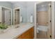 Bright bathroom with a large mirror, single sink and tiled floor at 10531 Pontofino Cir, Trinity, FL 34655
