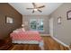 Bedroom with a hardwood floor, ceiling fan, and many windows at 10531 Pontofino Cir, Trinity, FL 34655