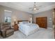Relaxing main bedroom with tray ceilings, carpet, ample natural light, and comfortable furniture at 10531 Pontofino Cir, Trinity, FL 34655