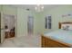 Bedroom with shutters on windows and an entryway into another room at 10531 Pontofino Cir, Trinity, FL 34655