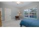 Sunlit bedroom with large windows and neutral colored walls at 10531 Pontofino Cir, Trinity, FL 34655