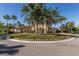 Stunning clubhouse with palm trees, a lush lawn, a circular drive with manicured landscaping and flower beds at 10531 Pontofino Cir, Trinity, FL 34655