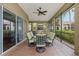 Spacious covered patio with dining table, chairs, ceiling fan, and views of the yard at 10531 Pontofino Cir, Trinity, FL 34655
