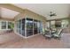 Expansive covered patio featuring outdoor living and dining areas with a ceiling fan at 10531 Pontofino Cir, Trinity, FL 34655