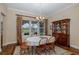 Well-lit dining room with hardwood floors, a hutch, and a large window overlooking the backyard at 10531 Pontofino Cir, Trinity, FL 34655