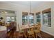 Bright dining room with wood floors, large windows and an adjacent view of the living room at 10531 Pontofino Cir, Trinity, FL 34655