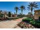 Community entrance with beautifully landscaped flower beds, brick trim, palm trees, and wrought iron gates that welcome residents at 10531 Pontofino Cir, Trinity, FL 34655