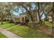 Attractive exterior view of home with a well-manicured lawn and mature trees enhancing the curb appeal at 10531 Pontofino Cir, Trinity, FL 34655