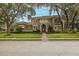 Stately two-story home features lush landscaping, mature trees, and a welcoming entrance, creating an inviting facade at 10531 Pontofino Cir, Trinity, FL 34655