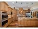 Gourmet kitchen with granite countertops, stainless steel appliances, and custom cabinets at 10531 Pontofino Cir, Trinity, FL 34655