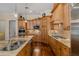 Gourmet kitchen with stainless steel appliances, granite countertops, and custom wood cabinetry at 10531 Pontofino Cir, Trinity, FL 34655